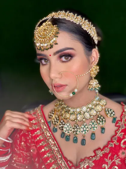 A direct, confident gaze from the bride. Her makeup is flawless, with a perfectly blended base and eyes that pop, making her look like a true queen.