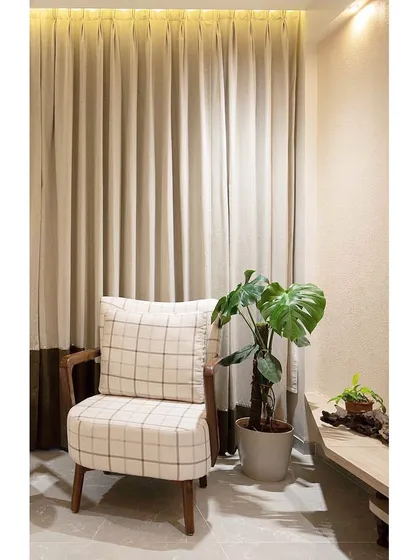 Another shot of the comfortable armchair, demonstrating how we create inviting nooks within a larger living space. The lighting is designed to be warm and relaxing.