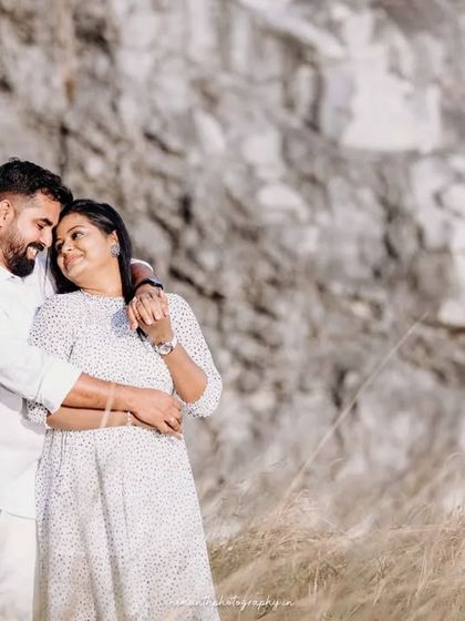 A joyful and candid shot of the couple sharing a laugh during their outdoor maternity session. Capturing these natural interactions is a key part of my photography style.