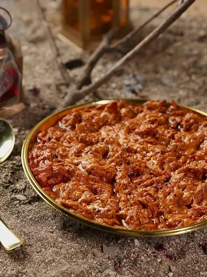 My Shahi Butter Chicken, a rich and creamy curry with tender pieces of chicken, available for order by the kilo. The dish is presented on a golden plate, emphasizing its royal flavor profile.