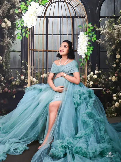 The same lovely teal gown, here used in a brighter setting with our golden birdcage prop, showing its versatility for different themes.