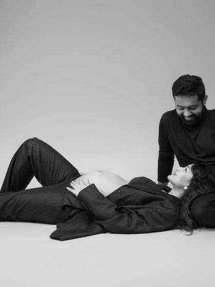 In this serene moment, love and anticipation entwine. The monochrome tone adds a touch of timelessness, while the gentle gestures and loving gazes speak volumes.