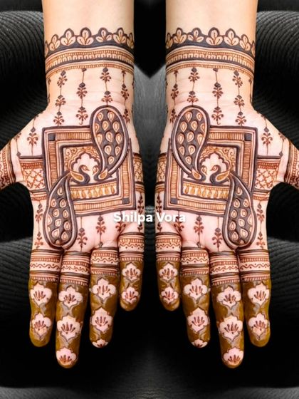 This peacock frame design is shown against a dark background, making the intricate patterns pop.