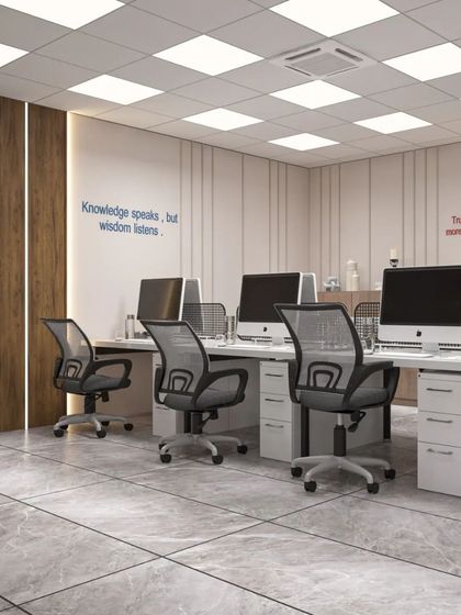 An open and bright workstation area with motivational quotes on the wall. The clean lines and minimalist design promote focus and clarity.
