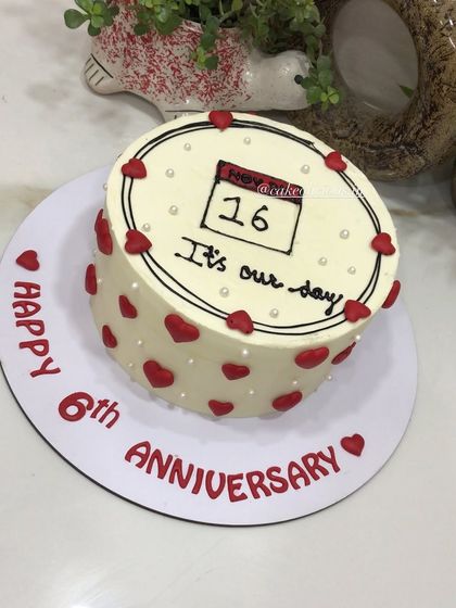 A beautiful way to mark your special day. This anniversary cake features a hand-drawn calendar with the significant date circled, surrounded by red hearts. A sweet and personal design.