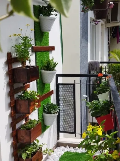 Another look at the vertical garden setup, showing how it can be combined with an artificial grass wall panel to create a stunning green feature on a balcony.