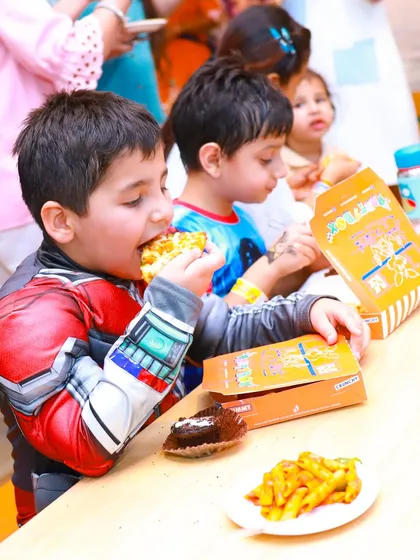 A young superhero refuels with pizza and pasta from our Snack Box.