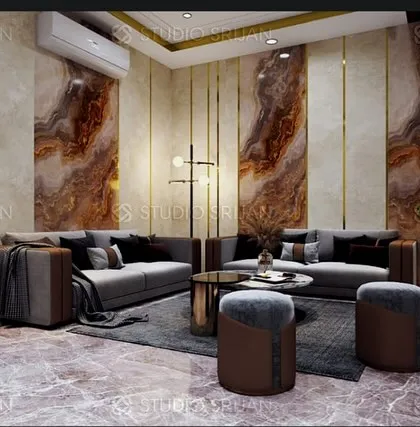This lobby in DLF, Gurgaon, features dramatic, book-matched marble panels with gold-tone metal inlays, creating a powerful statement of luxury.