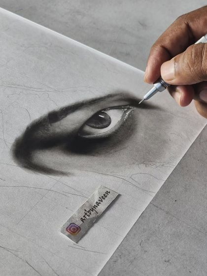 A close-up of an eye I'm drawing, showing the initial layers of graphite that form the base for the details.