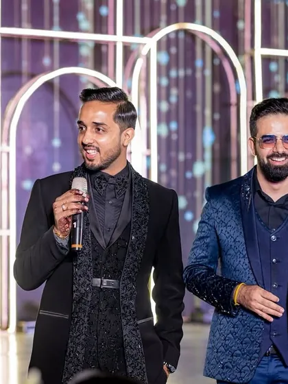 A candid moment on stage with the groom. These are the interactions that build the energy and make the night special for everyone involved.