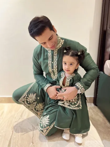 A closer look at the bond between a father and daughter. The custom matching kurta sets are crafted from soft mul mul fabric, with detailed leather embroidery on the neckline and hem, making it a comfortable yet elegant choice for festive family photos.