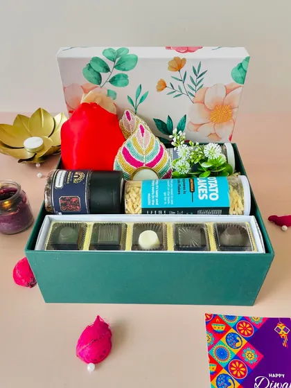 A front-on view of the floral box, showcasing the assortment of gourmet snacks and the elegant packaging.