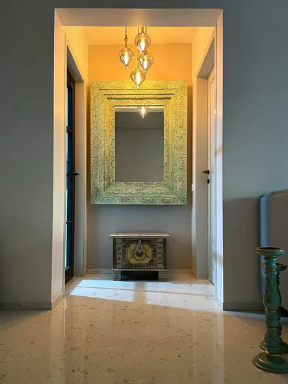 Every corner tells a story. This entryway nook uses an intricately carved mirror and a small chest to establish the home's unique Bohemian character from the moment you step inside.