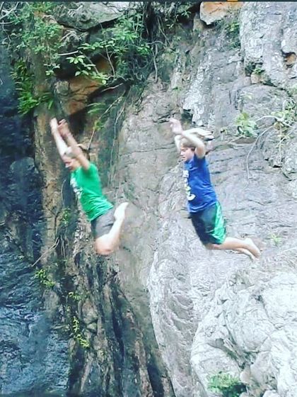 We also run programs for kids, teaching them to be confident and capable in the outdoors. Here, two young adventurers take a leap of faith with a cliff jump.