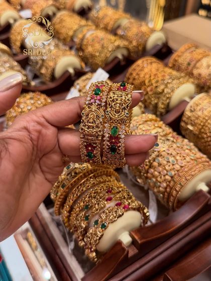 A close-up of my antique bangles with intricate floral work and studded with ruby and emerald colored stones. These start from just ₹120.
