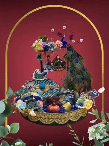 For Teej, we go all out with traditional elegance. This elaborate hamper features peacock feathers, intricate floral work, and classic motifs like elephants, all designed around the special gifts you want to include for your loved ones.