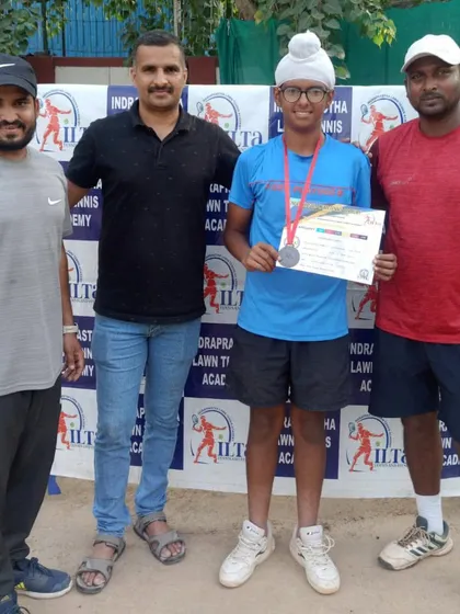 One of our players with his coaches after receiving his medal. The support of the team is crucial for a player's development.