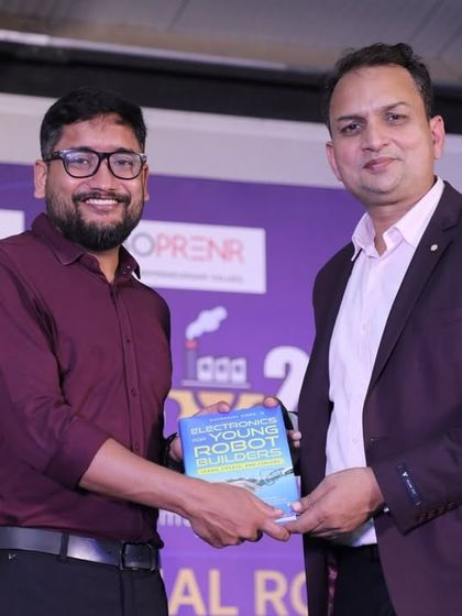 Our founder presents a copy of his book to an ISRO scientist at the RW 2024 competition. Our resources are recognized and valued by experts in the field.