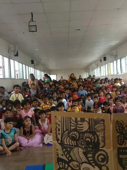 A wide shot of the audience during one of our school shows. The sheer number of happy faces is what motivates us.