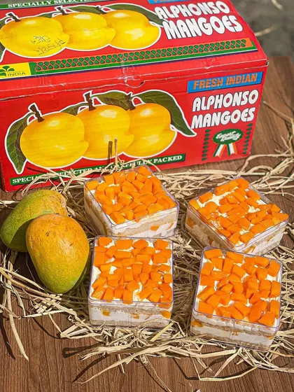 My fresh Alphonso mango cake tubs are a seasonal favorite, packed with layers of light cake, cream, and sweet mango chunks.