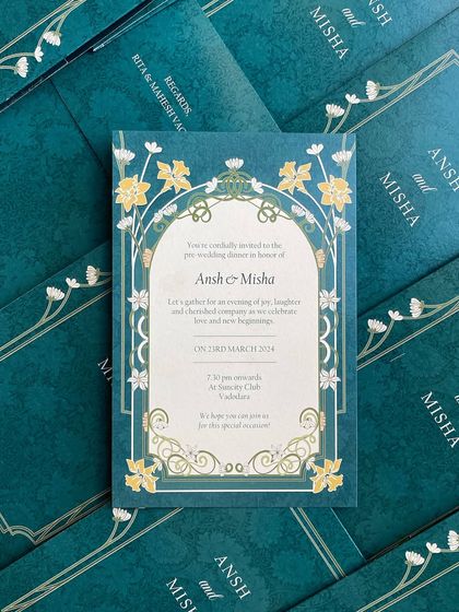 The invitation card that goes inside the teal folder. The design features an art nouveau-inspired floral border that complements the classic frame on the folder.