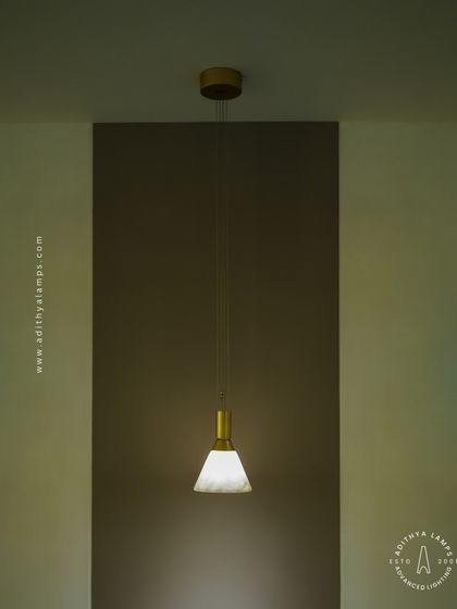 This image shows the single pendant light creating a focused pool of light, ideal for accentuating a specific area or creating an intimate mood. Its simple form makes it a timeless choice for any decor.