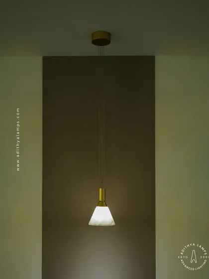 This image shows the single pendant light creating a focused pool of light, ideal for accentuating a specific area or creating an intimate mood. Its simple form makes it a timeless choice for any decor.