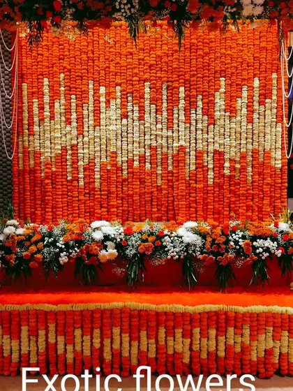 We created a stunning floral soundwave pattern using thousands of fresh marigold and tuberose flowers for this large-scale backdrop. This unique design shows how we can transform traditional flowers into a modern art piece, making it a vibrant and memorable focal point for any event.