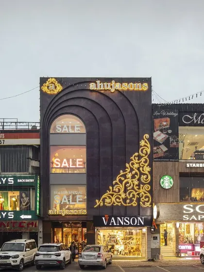 The facade of the Ahujasons flagship store in New Delhi is a statement of modern heritage. The copper-arched exterior reinterprets tradition through a contemporary lens, demonstrating our approach to creating a strong and unique brand presence from the outside in.
