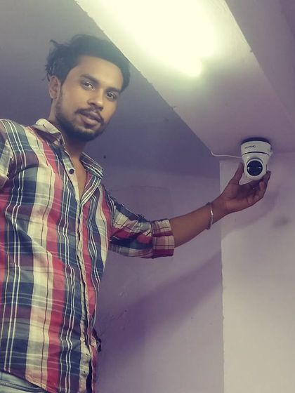 A member of our team positioning an indoor dome camera. We ensure every corner is watched.