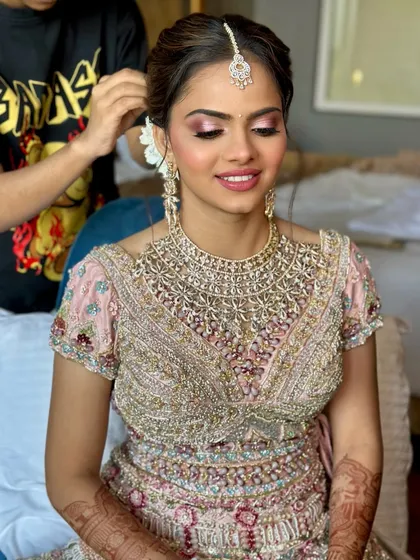 A behind the scenes glimpse of perfecting the hair for this pastel bridal look. The soft pink eyeshadow and luminous skin are central to achieving this modern and romantic aesthetic.
