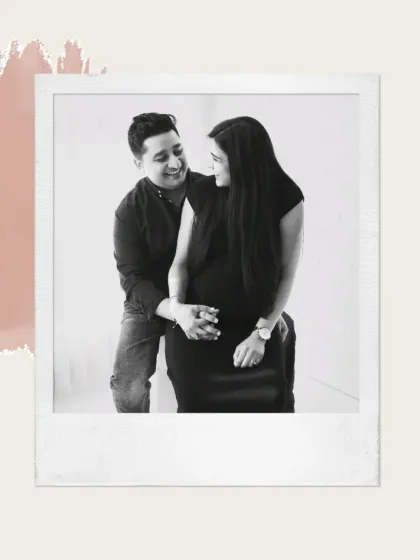 A sweet and intimate black and white portrait. The couple shares a loving look, creating a classic and romantic image from their maternity session.