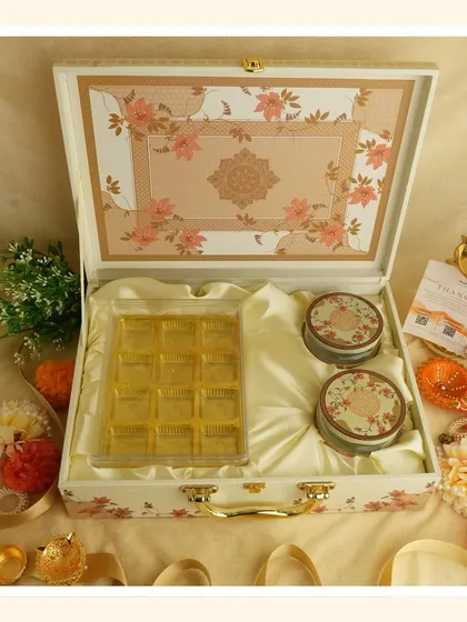 Embrace the purity of white for Navratri. This elegant floral suitcase box is perfect for gifting sweets and dry fruits as you transition into the Diwali season.