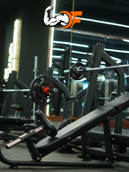 The strength training area features top-of-the-line equipment, including various benches and racks, to ensure you can perform exercises safely and effectively.