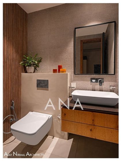 Another guest washroom in Apartment 704, showcasing a different material palette. Here, textured tiles and a wooden vanity create a warm, minimalist aesthetic in a small space.