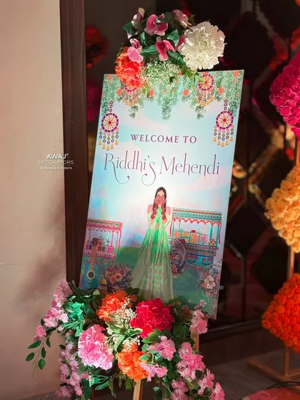 A personalized welcome sign for the Mehendi, featuring a beautiful illustration of the bride, surrounded by colorful flowers.