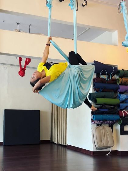 Another moment of creating shapes in the air. This pose, cradled in the hammock, is a beautiful combination of a backbend and a gentle twist.