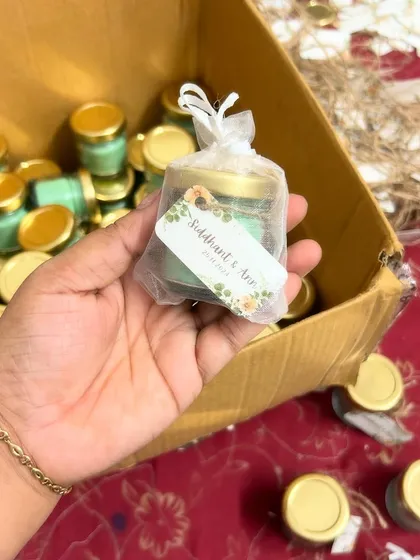 For a simple and elegant packaging option, we offer these delicate net potlis. Here, a mini candle for Siddhant and Ann's wedding is ready to be gifted.