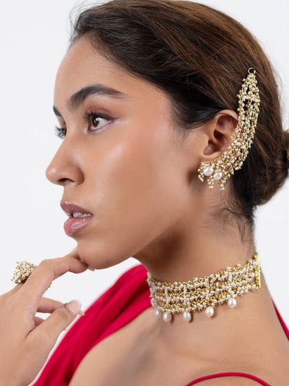 Uniqueness is what every woman desires. This pearl and gold earcuff paired with a matching choker is a sold-out favorite.