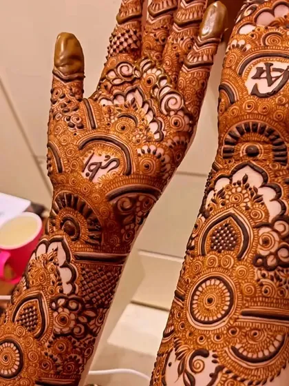 Another view of the final stain, highlighting the customized 'A' initial on the palm. You can see how the intricate patterns and shading translate into a stunning and long-lasting henna design.