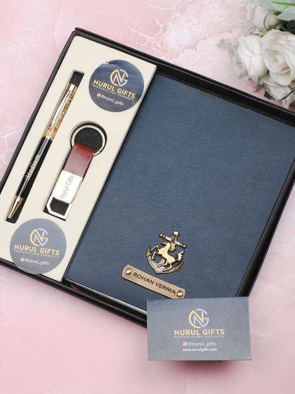 A beautiful gift set for a professional, including a personalized diary, pen, and keychain, all with custom names and charms.