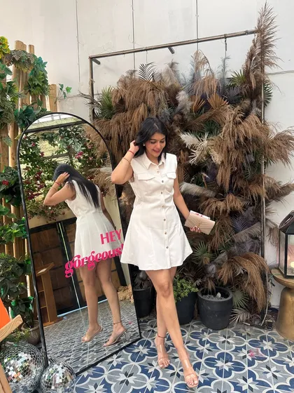 Another full-length shot of the white shirt dress. The A-line silhouette is flattering for many body types, including pear shapes.
