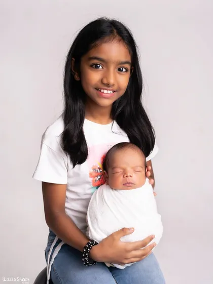 A beautiful portrait of a big sister holding her new best friend. These are the photos that will be cherished for a lifetime as their bond continues to grow.