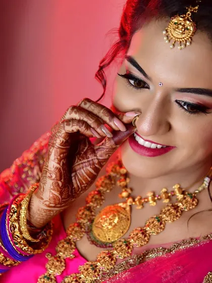 A close-up of Tanu's engagement look, featuring a playful nose-ring touch. Her makeup is glamorous with a bold lip, perfect for the occasion.