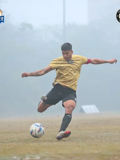 A powerful follow-through on a shot or long pass, demonstrating the technique and force our players possess.