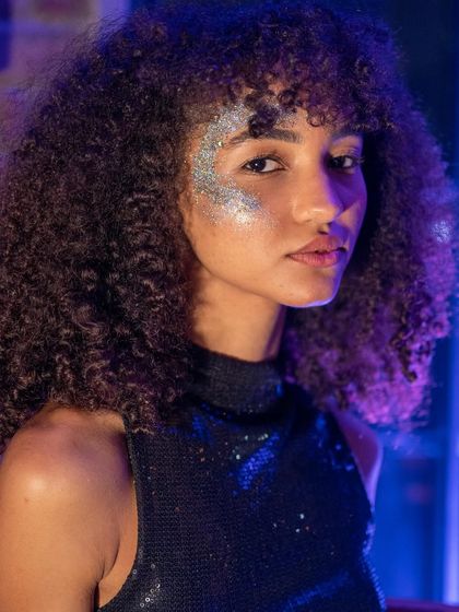 A stunning portrait of a guest with glitter makeup. The creative and expressive crowd is a huge part of what makes my events special.