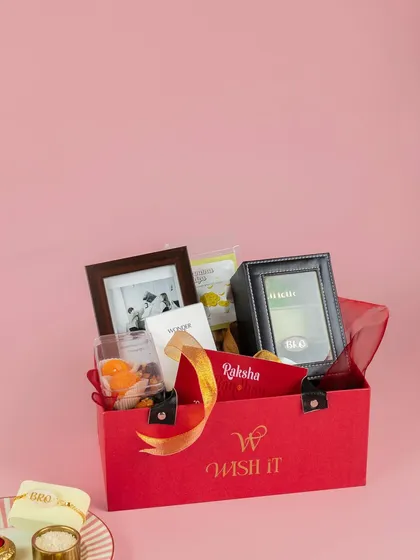 Our Rakhi hamper for brothers, "The Bro Bond Box". It includes a watch box, a photo frame, snacks, and other goodies for your partner-in-crime.