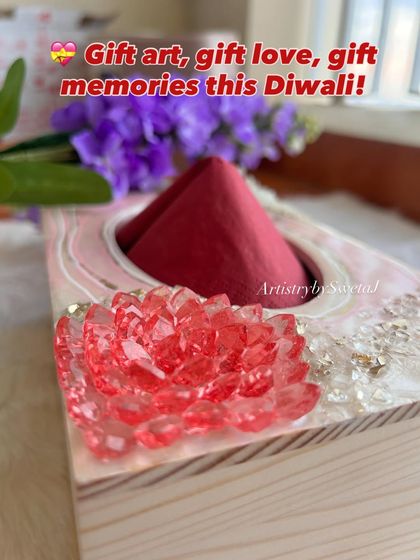 The perfect Diwali gift that blends art and utility. This pinewood napkin holder is decorated with a stunning pink and white resin geode design.