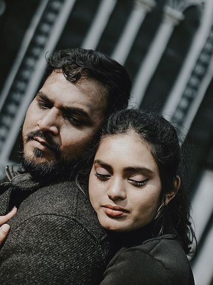 An intimate and emotional embrace, captured in a moody, high-contrast black and white style.