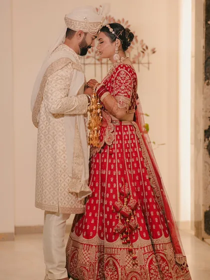 A full length portrait showcasing the couple's stunning wedding attire. Their pose is both elegant and intimate, reflecting their connection.